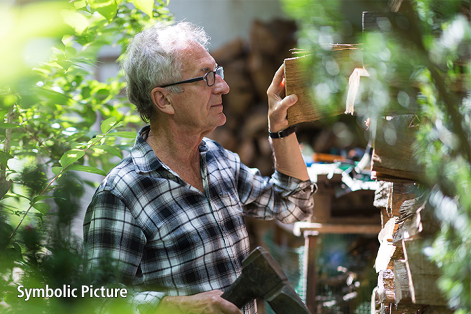 Man with Alzheimer's looking at logs.